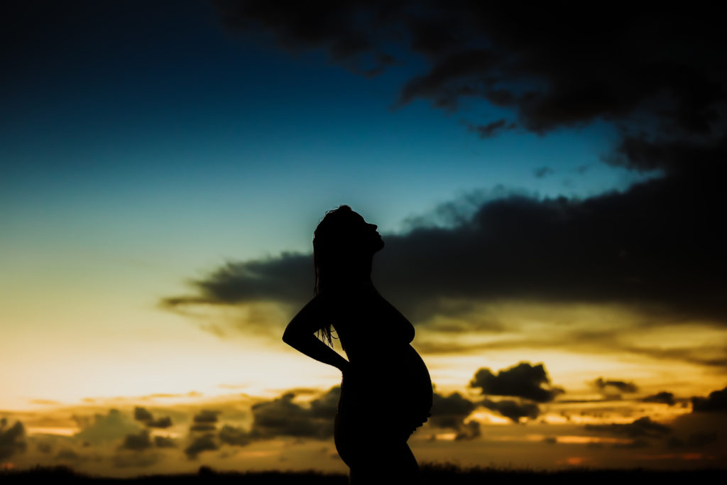 silhouette maternity portrait at the beach 